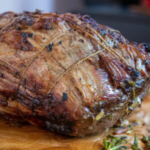 Deliciously roasted beef seasoned with herbs, perfect for festive gatherings.