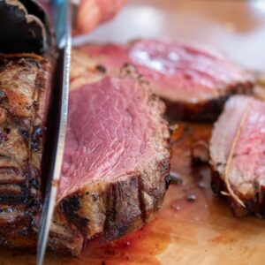 Appetizing close-up of a succulent sliced roast beef with a knife.
